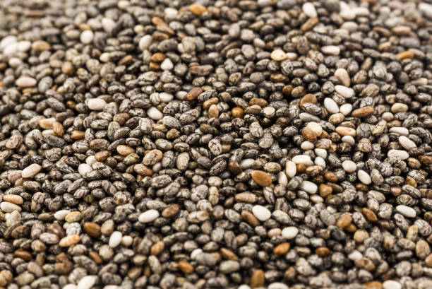 istock Texture background of chia beans for design. chia grains scattered on the table 1218269192
