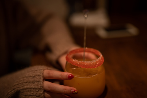 Woman holding cocktail-like nonalcoholic beverages