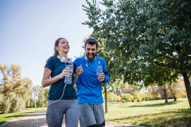 istock Cheerful athletes jogging outdoors at a park 1218274680
