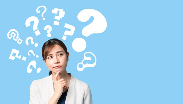 istock Thinking young asian businesswoman with question mark. 1218281866