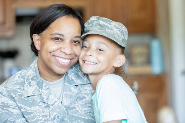 istock Daughter wears mothers military hat 1218283608