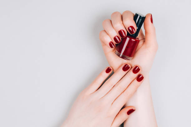 istock Female hands with nail polish 1218283724