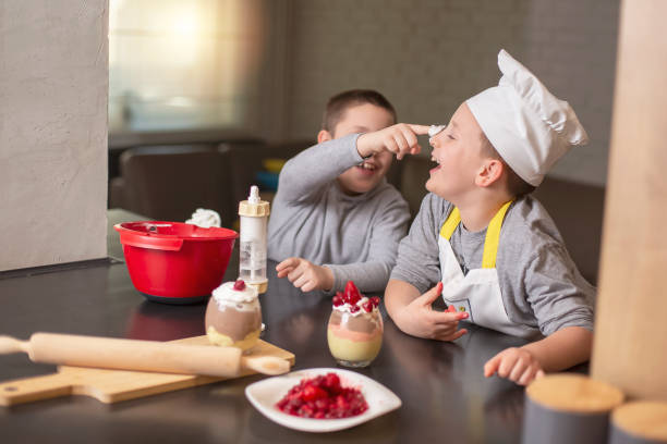 istock Two boys, brothers, preparing dessert at home 1218284684