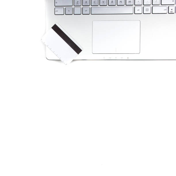 istock The mockup credit card is put on a laptop on white table with coffee cup. Top view copy space. 1218284883