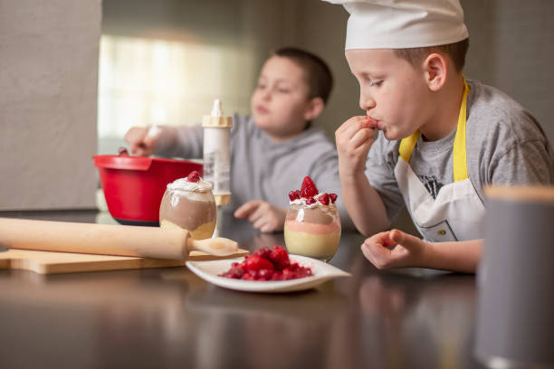 istock Two boys, brothers, preparing dessert at home 1218285211
