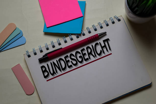istock Bundesgericht write on a book isolated on office desk. German Language it means Supreme Court 1218289310