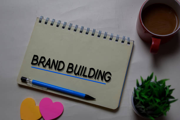 istock Brand Building write on a book isolated on office desk. 1218289314
