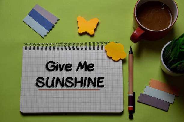 istock Give Me Sunshine write on a book isolated on office desk. 1218289355