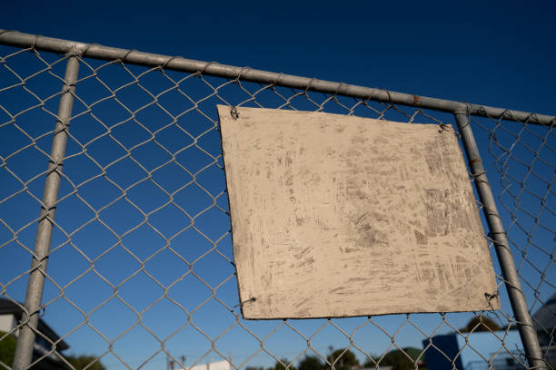 istock Empty white sign on  fence offers copy space. 1218293147
