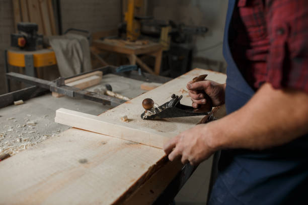 istock The master carpenter works with tree in workshop. Close-up 1218293156