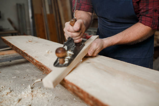istock The master carpenter works with tree in workshop. Close-up 1218293176