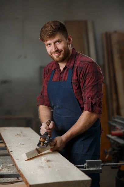 istock The master carpenter works with the tree in the workshop. Small business 1218293177