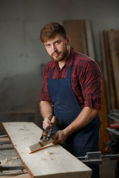 istock The master carpenter works with the tree in the workshop. Small business 1218293178