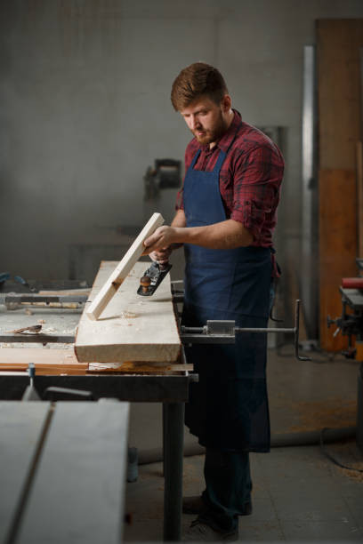istock The master carpenter works with the tree in the workshop. Small business 1218293187