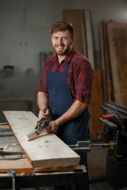 istock The master carpenter works with the tree in the workshop. Small business 1218293190