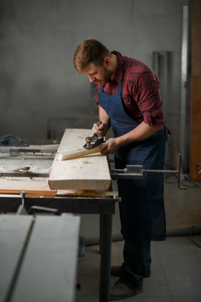 istock The master carpenter works with the tree in the workshop. Small business 1218293191