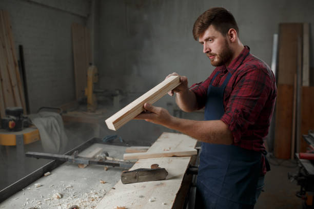 istock The master carpenter works with the tree in the workshop. Small business 1218293225