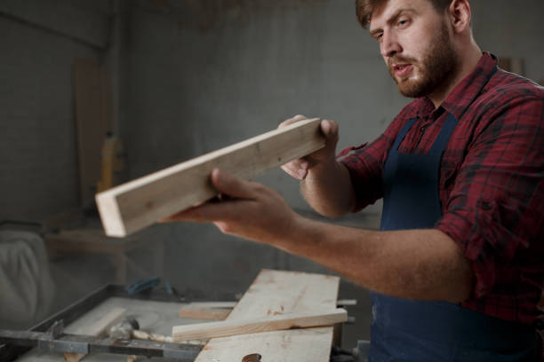 istock The master carpenter works with the tree in the workshop. Small business 1218293233