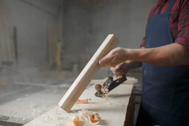 istock The master carpenter works with tree in workshop. Close-up 1218293259