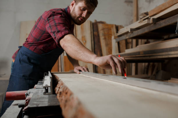 istock The master carpenter works with the tree in the workshop. Small business 1218293843