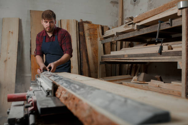 istock The master carpenter works with the tree in the workshop. Small business 1218293858