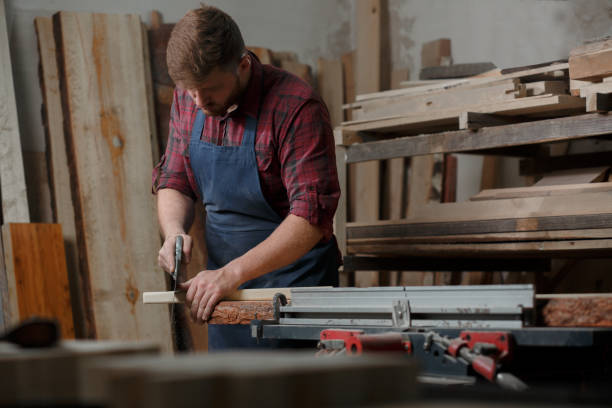 istock The master carpenter works with the tree in the workshop. Small business 1218293887