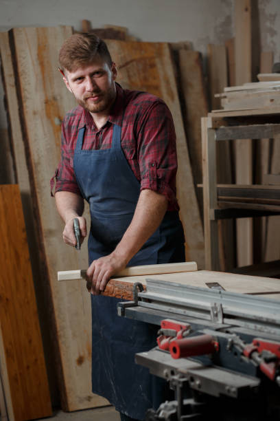 istock The master carpenter works with the tree in the workshop. Small business 1218293903