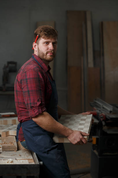 istock The master carpenter works with the tree in the workshop. Small business 1218293958