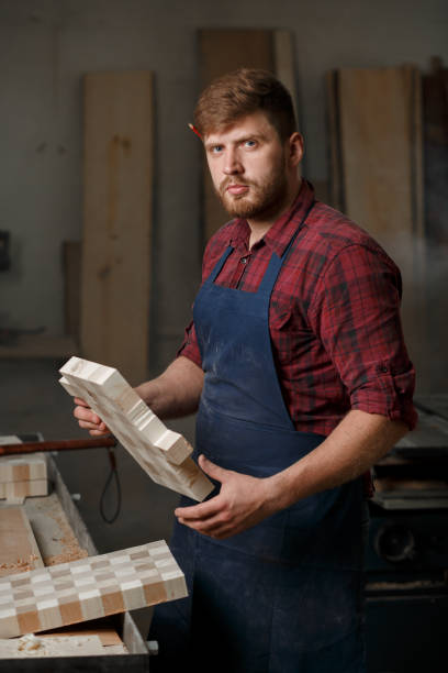 istock The master carpenter works with the tree in the workshop. Small business 1218293992