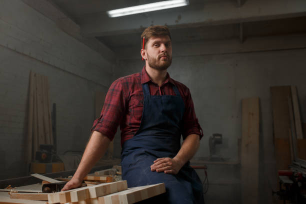 istock The master carpenter works with the tree in the workshop. Small business 1218294009