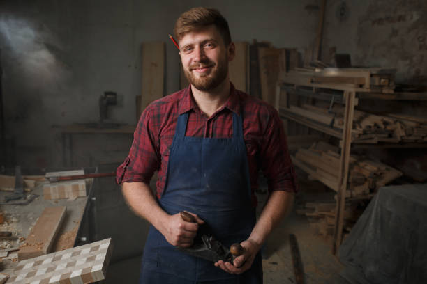 istock The master carpenter works with the tree in the workshop. Small business 1218294078