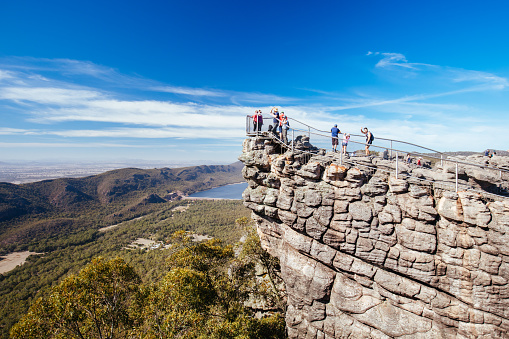 Crowds take in the iconic views from Pinnacle Lookout over Halls Gap and surrounds on the Wonderland hike loop in Victoria, Australia