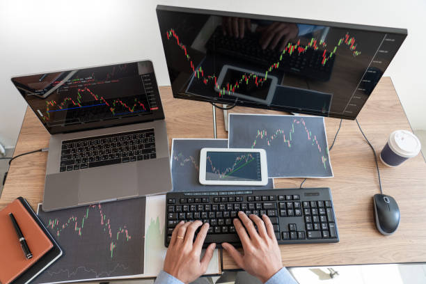 istock Working business man, team of broker or traders talking about forex on multiple computer screens of stock market invest trading financial graph charts data analysis 1218300315
