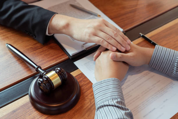 istock Lawyer working with client discussing contract papers with brass scale about legal legislation in courtroom, consulting to help their customer 1218301426