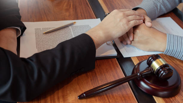 istock Lawyer working with client discussing contract papers with brass scale about legal legislation in courtroom, consulting to help their customer 1218301498