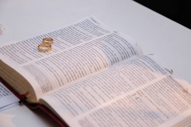 istock Wedding concept. Wedding rings together with the bible 1218302623