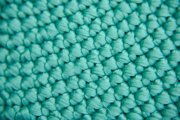 istock Repeating texture of knitted green fiber. Selective focus. Close-up look. 1218305964