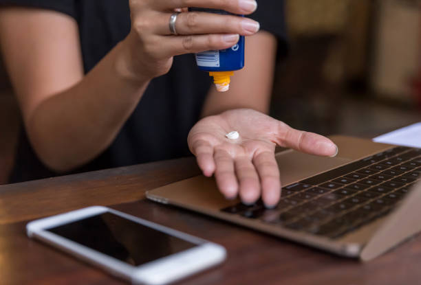 istock Asian woman applying hand moisturizer before working on laptop 1218307671