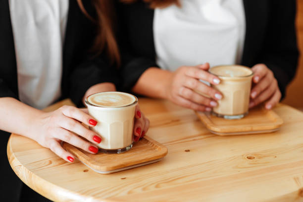 istock hands holding cup of coffee in coffee shop 1218308622
