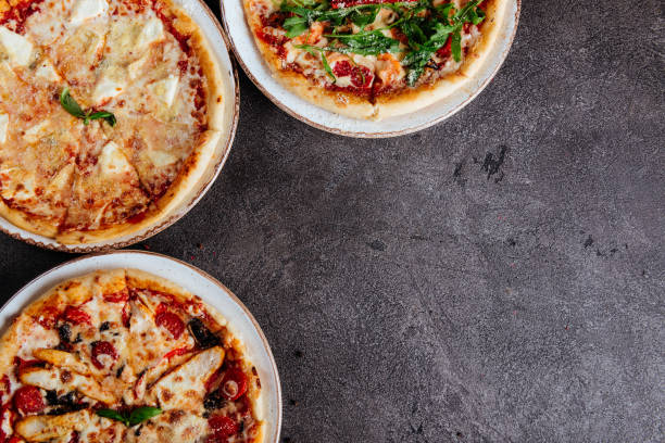 istock Traditional Italian pizza on a dark background top view 1218308640