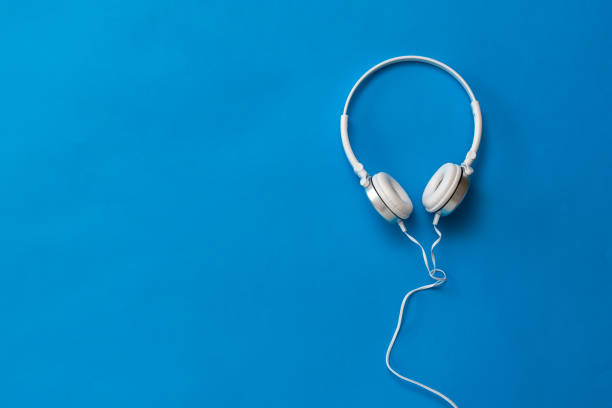 istock Classic white headphones on a rich blue background. 1218308665
