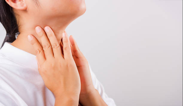 istock Asian beautiful woman Sore Throat or thyroid gland problem her useing Hand Touching Ill Neck on white background with copy space, Medical and Healthcare concept 1218310457