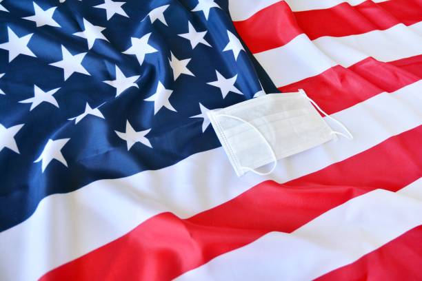 istock Protective surgical face mask on American national flag. 1218311914