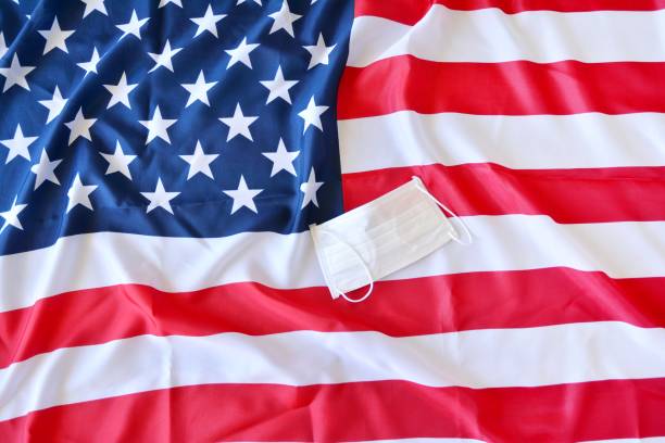 istock Protective surgical face mask on American national flag. 1218311936