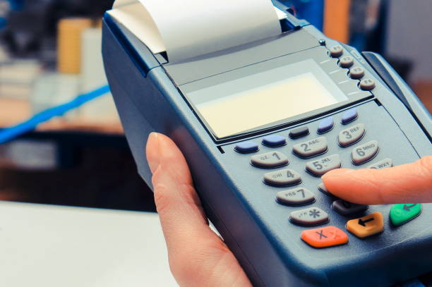 istock Paying with credit card in electrical shop, enter personal identification number 1218312532