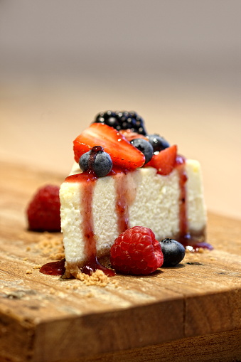 slice of cheesecake with red fruit sauce