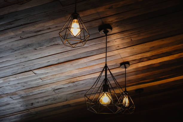 istock Beautiful vintage luxury light bulb hanging decor glowing in dark. 1218314129