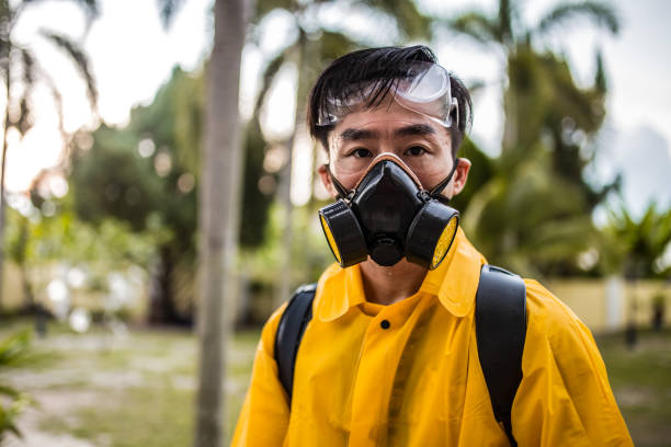 Blue collar worker at factory. He is wearing safety suit.