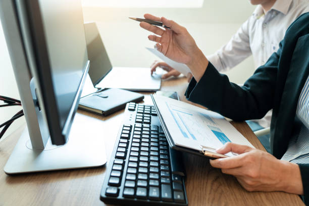istock Working business man, team of broker or traders talking about forex on multiple computer screens of stock market invest trading financial graph charts data analysis 1218316325