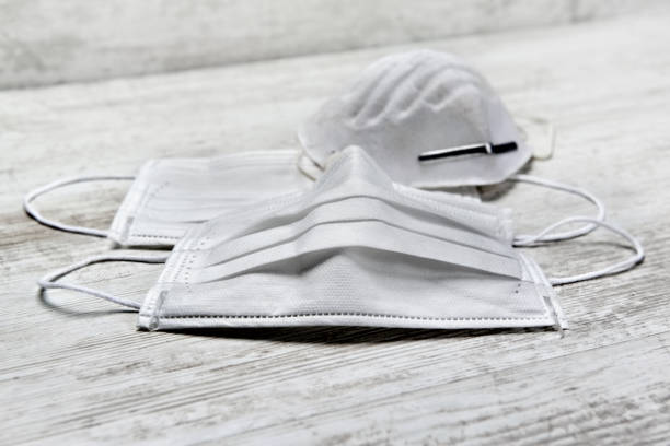 istock white medical and dust masks on a table 1218319312